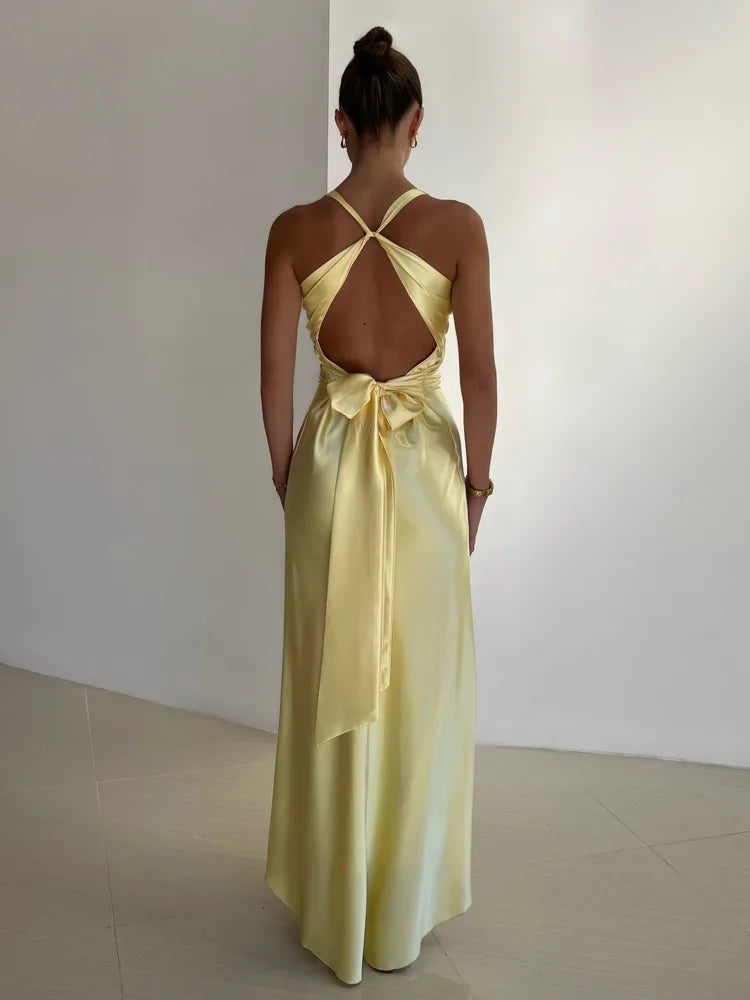 Floor-Length Backless Evening Gown in Radiant Yellow for Festive Occasions | Flowing Criss-Cross Back Formal Dress with Deep V Neckline and Waist Tie Detailing | Koossa